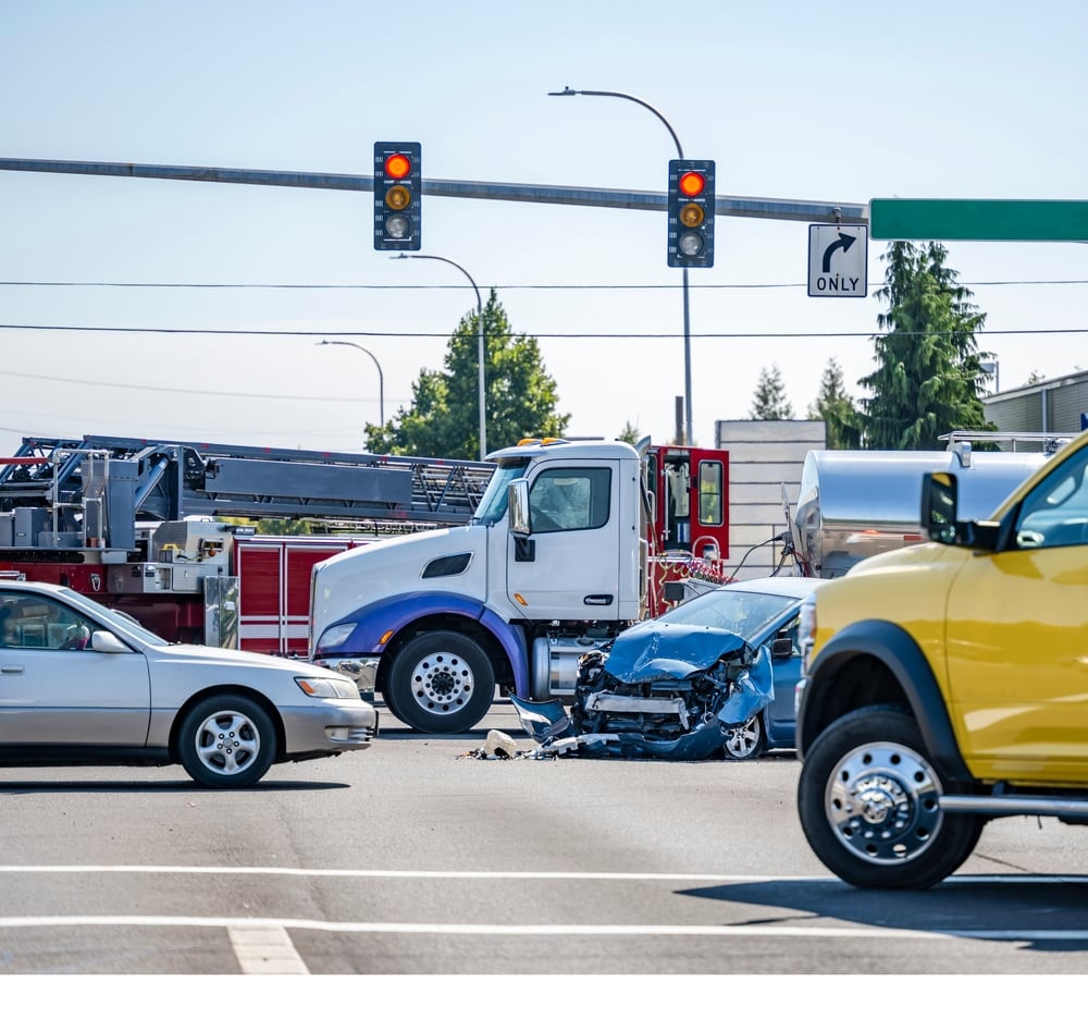 Cars badly damaged after a collision with a large 18-wheeler truck