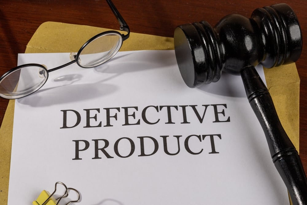 Defective Product heading printed on legal documents on a desk